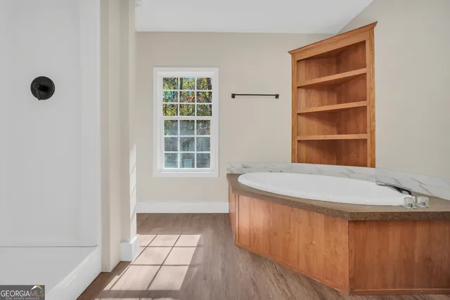 a bathroom with a tub and a window