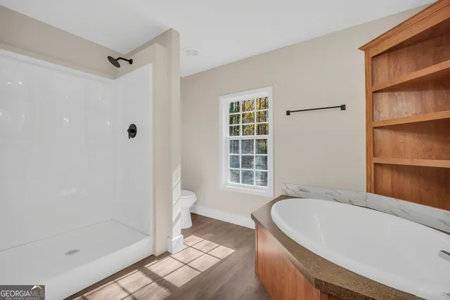 a bathroom with a tub a sink and a shower