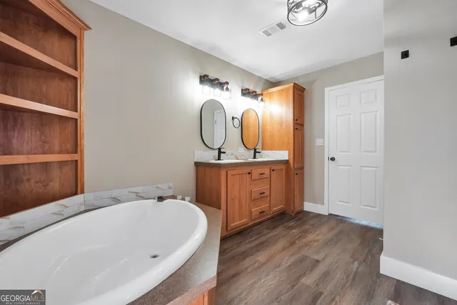 a bathroom with a sink a mirror and a bathtub