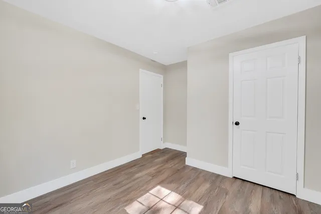 a view of an empty room and wooden floor