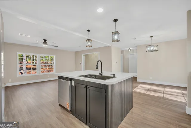 a kitchen with a stove and wooden floor