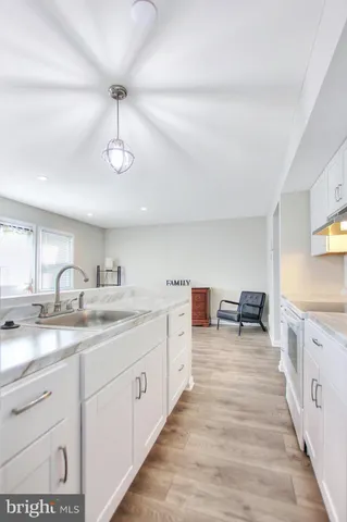 a spacious bathroom with double vanity and a mirror