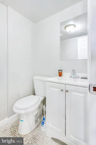 a white toilet sitting next to a bathroom sink