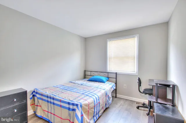 a bedroom with a bed and a desk