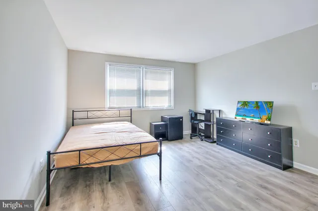 a bedroom with furniture and a window