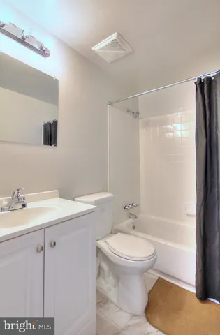 a bathroom with a granite countertop sink toilet a mirror and shower