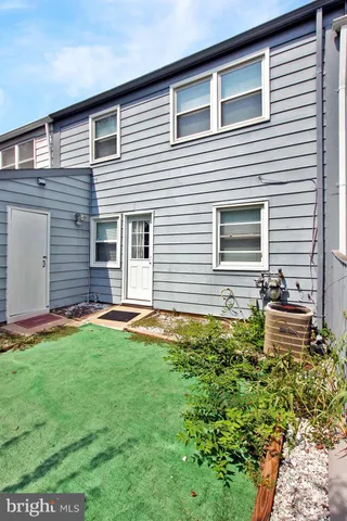 a view of a house with pool and sitting area