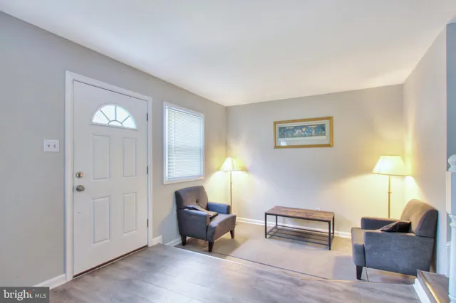 a living room with furniture and a lamp