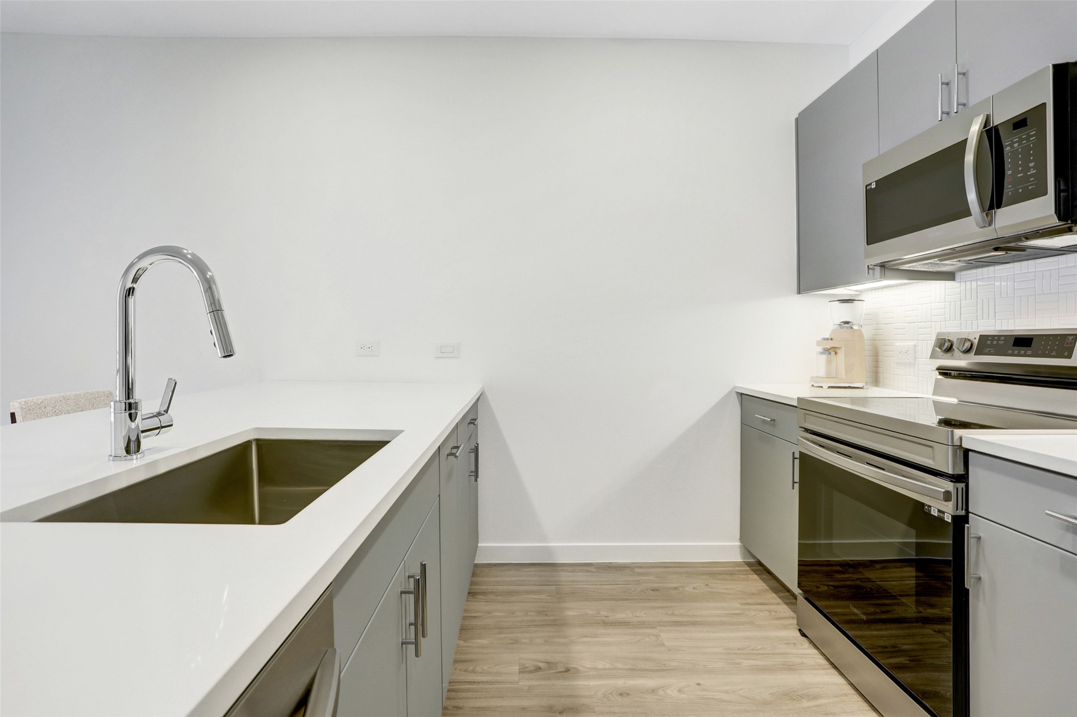 4801 Springdale Road, Unit 2309 Austin, TX 78723 - Photo 10 of 15 Fitted with quartz countertops and stainless steel appliances, this kitchen combines clear utility with an inviting layout that helps you feel right at home while cooking your favorite meals