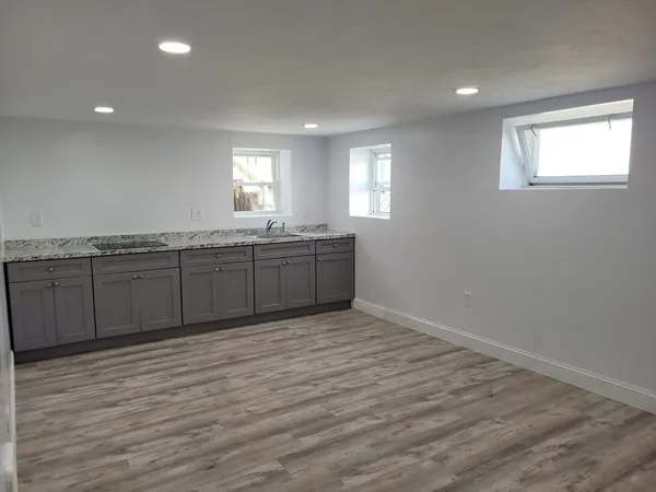 a view of a kitchen counter space and wooden floor