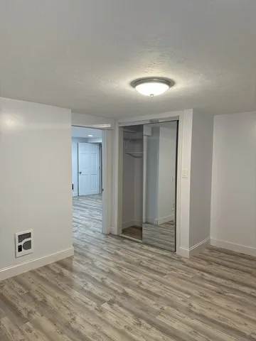 a view of an empty room with closet and chandelier fan