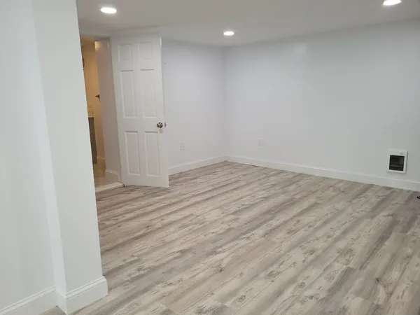 a view of hallway with wooden floor
