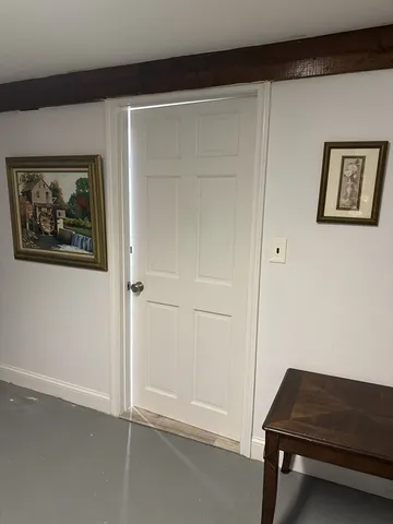 a room that has a bed and a table chair