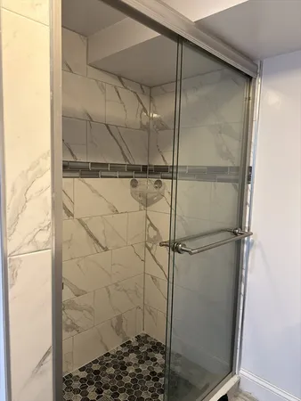 a bathroom with a glass shower door