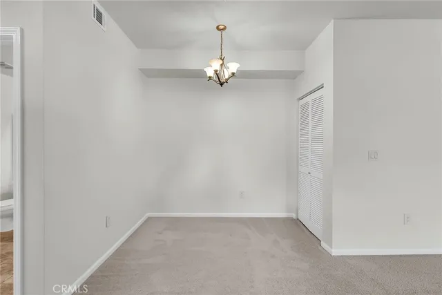 an empty room with a ceiling fan and window