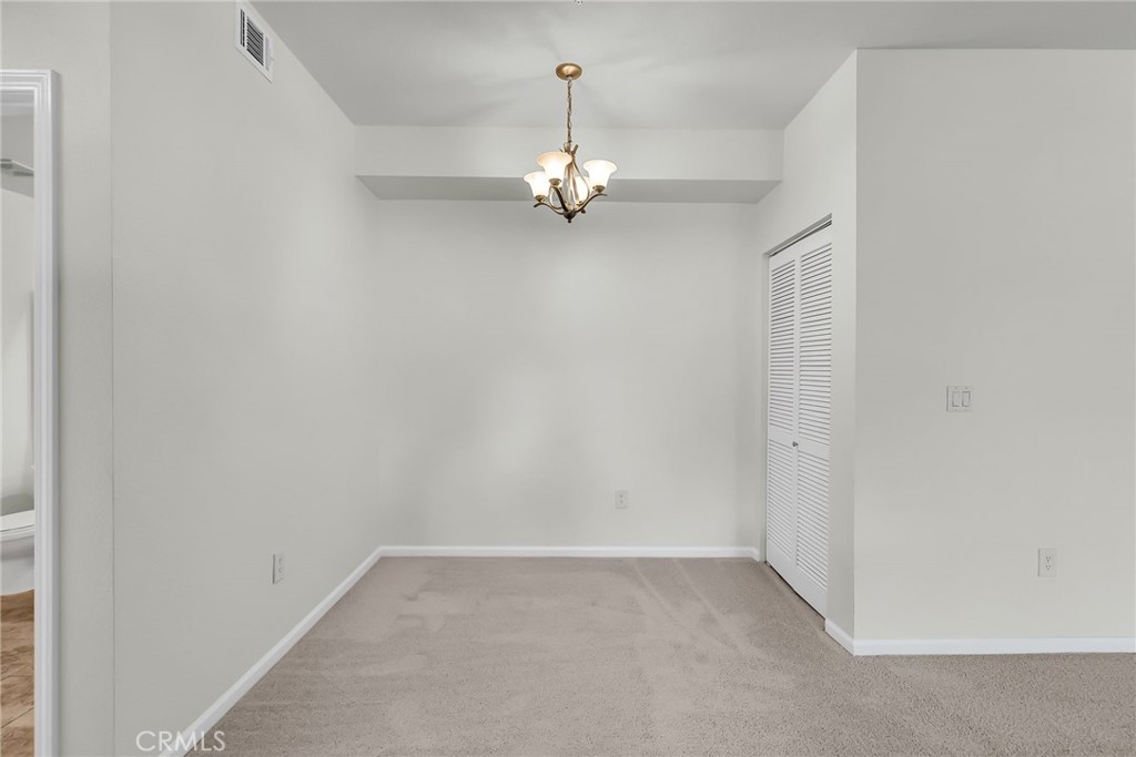 375 Central Avenue, Unit 83 Riverside, CA 92507 - Photo 12 of 29 an empty room with a ceiling fan and window