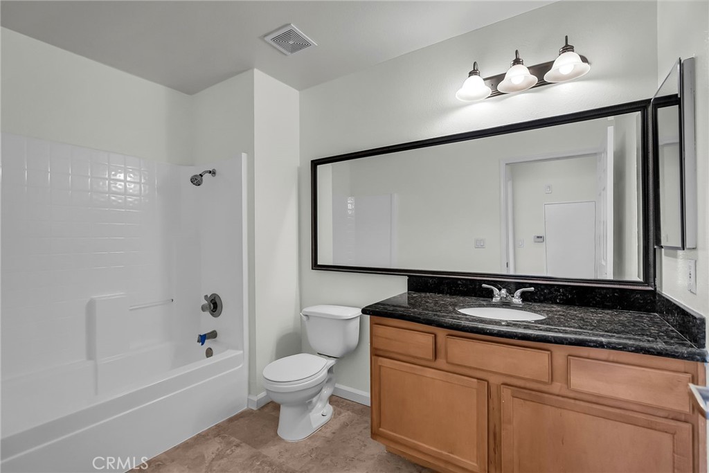 375 Central Avenue, Unit 83 Riverside, CA 92507 - Photo 14 of 29 a bathroom with a granite countertop sink a toilet and mirror