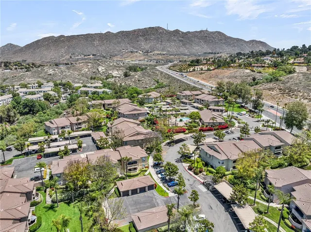 an aerial view of residential houses with outdoor space and mountain view