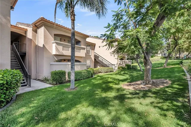 a view of a house with a yard and plants