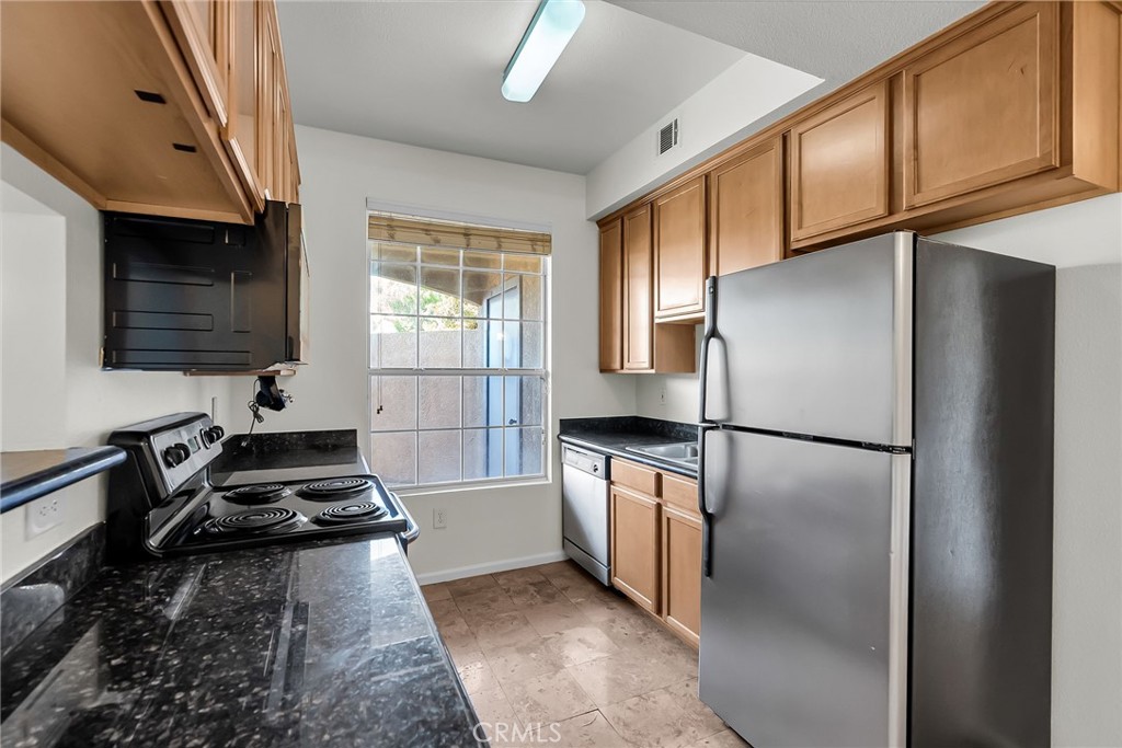 375 Central Avenue, Unit 83 Riverside, CA 92507 - Photo 4 of 29 a kitchen with a refrigerator a stove and a sink