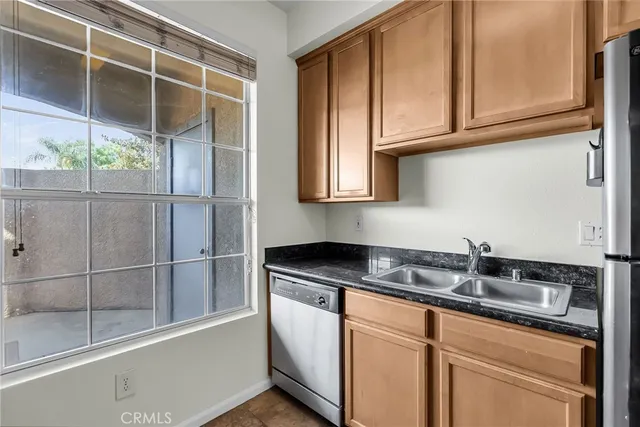 a kitchen with stainless steel appliances granite countertop a sink and cabinets