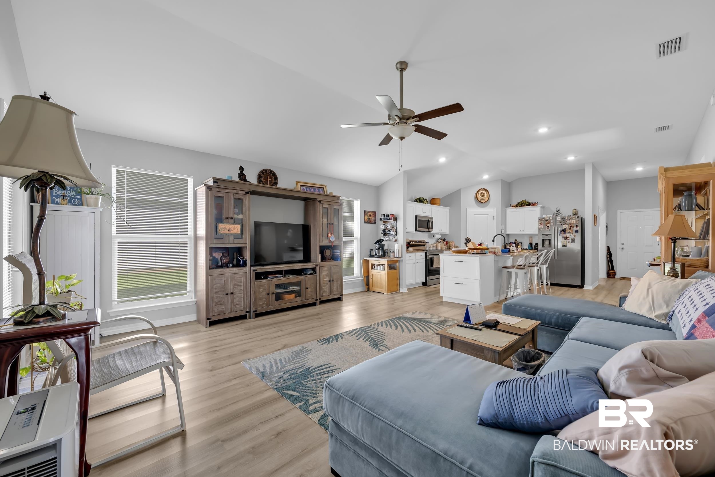1228 Caper Avenue Foley, AL 36535 - Photo 11 of 54 Open-concept living area featuring vaulted ceilings, wood-finish flooring, and recessed lighting