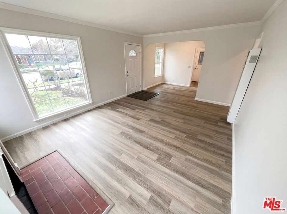 3237 Daisy Avenue Long Beach, CA 90806 - Photo 18 of 28 a view of an empty room with wooden floor and a window