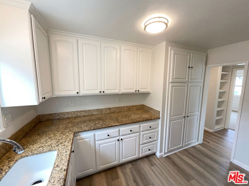 3237 Daisy Avenue Long Beach, CA 90806 - Photo 20 of 28 a kitchen with granite countertop a sink cabinets and stainless steel appliances