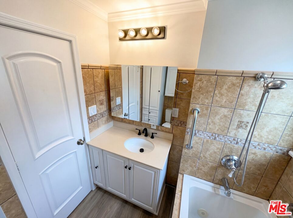 3237 Daisy Avenue Long Beach, CA 90806 - Photo 26 of 28 a bathroom with a sink a mirror and shower