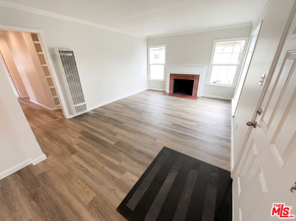 3237 Daisy Avenue Long Beach, CA 90806 - Photo 3 of 28 a view of a livingroom with wooden floor and fireplace