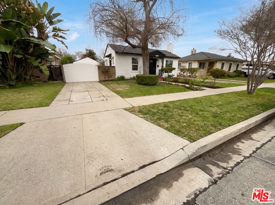 3237 Daisy Avenue Long Beach, CA 90806 - Photo 7 of 28 a front view of a house with a yard