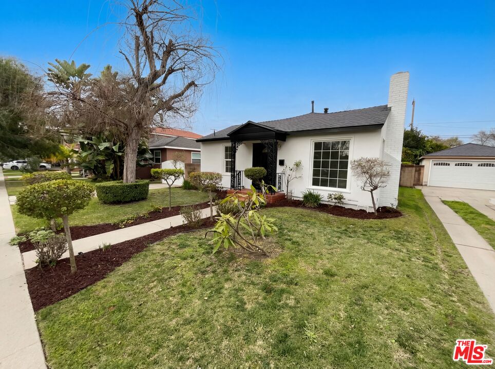 3237 Daisy Avenue Long Beach, CA 90806 - Photo 8 of 28 a front view of a house with garden