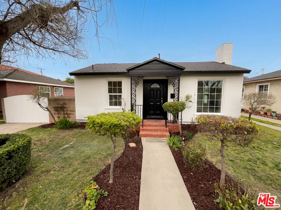 3237 Daisy Avenue Long Beach, CA 90806 - Photo 9 of 28 a view of a house with large windows and a yard