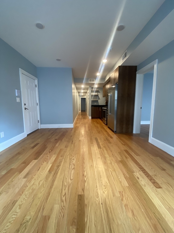 186 Kelton Street, Unit 2 Boston, MA 02134 - Photo 4 of 11 a big room with wooden floor