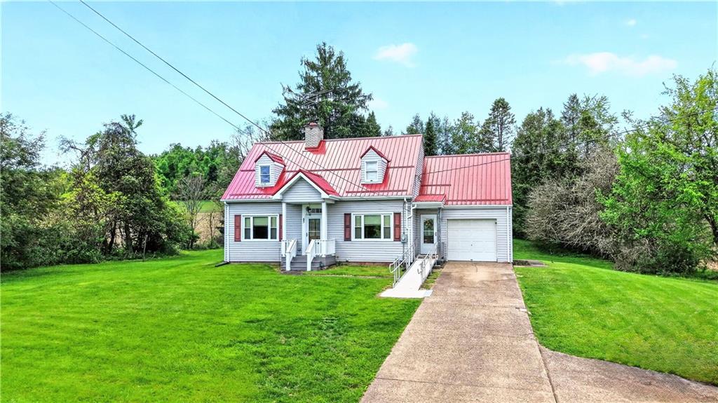 607 Cemetery Road Perryopolis, PA 15473 - Photo 1 of 30 a front view of house with yard and green space
