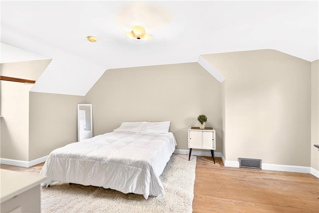 607 Cemetery Road Perryopolis, PA 15473 - Photo 12 of 30 a bedroom with a bed and a potted plant