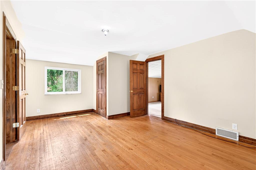 607 Cemetery Road Perryopolis, PA 15473 - Photo 16 of 30 an empty room with wooden floor and windows