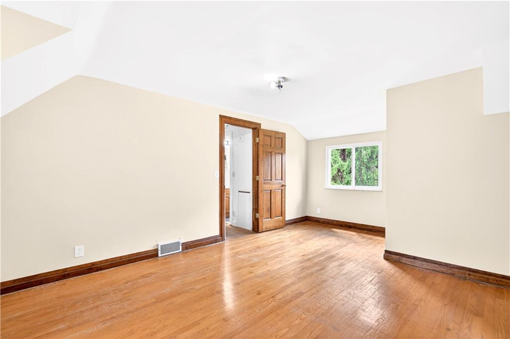 607 Cemetery Road Perryopolis, PA 15473 - Photo 17 of 30 a view of an empty room with wooden floor and a window