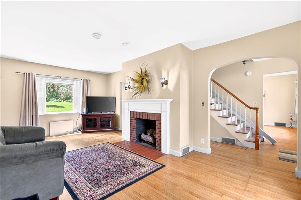 607 Cemetery Road Perryopolis, PA 15473 - Photo 3 of 30 a living room with furniture and a fireplace