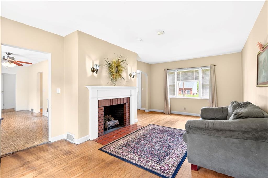 607 Cemetery Road Perryopolis, PA 15473 - Photo 4 of 30 a living room with furniture and a fireplace