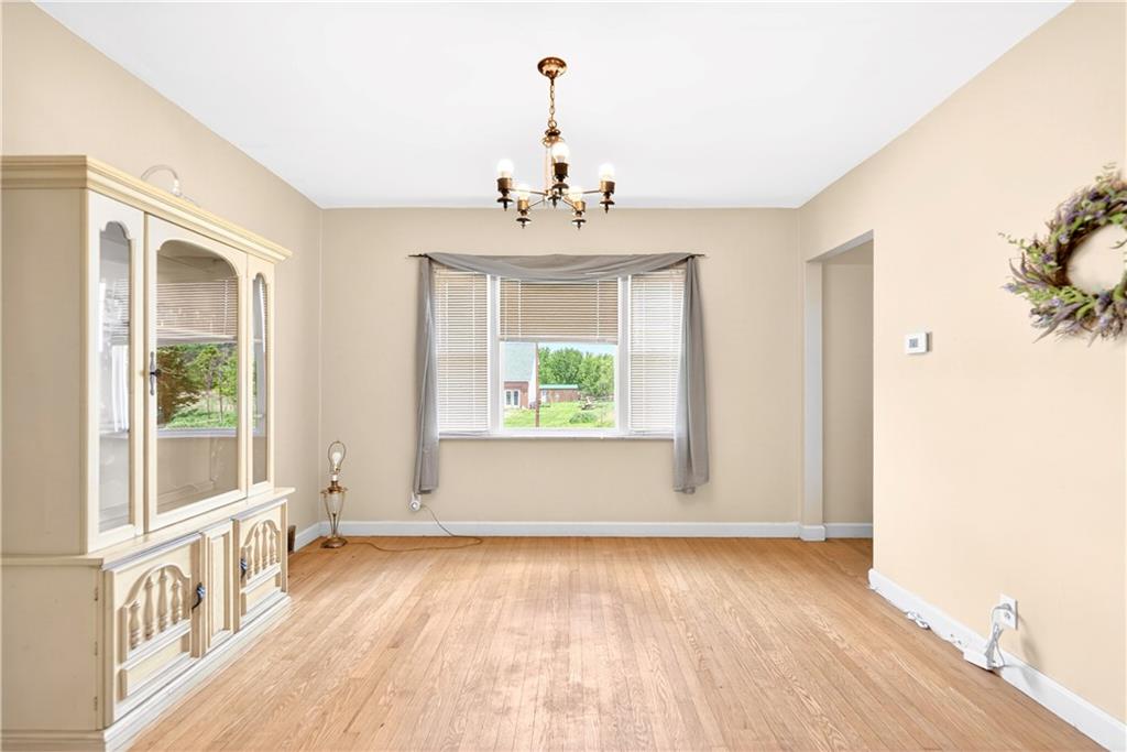 607 Cemetery Road Perryopolis, PA 15473 - Photo 5 of 30 a view of an empty room with wooden floor and a window