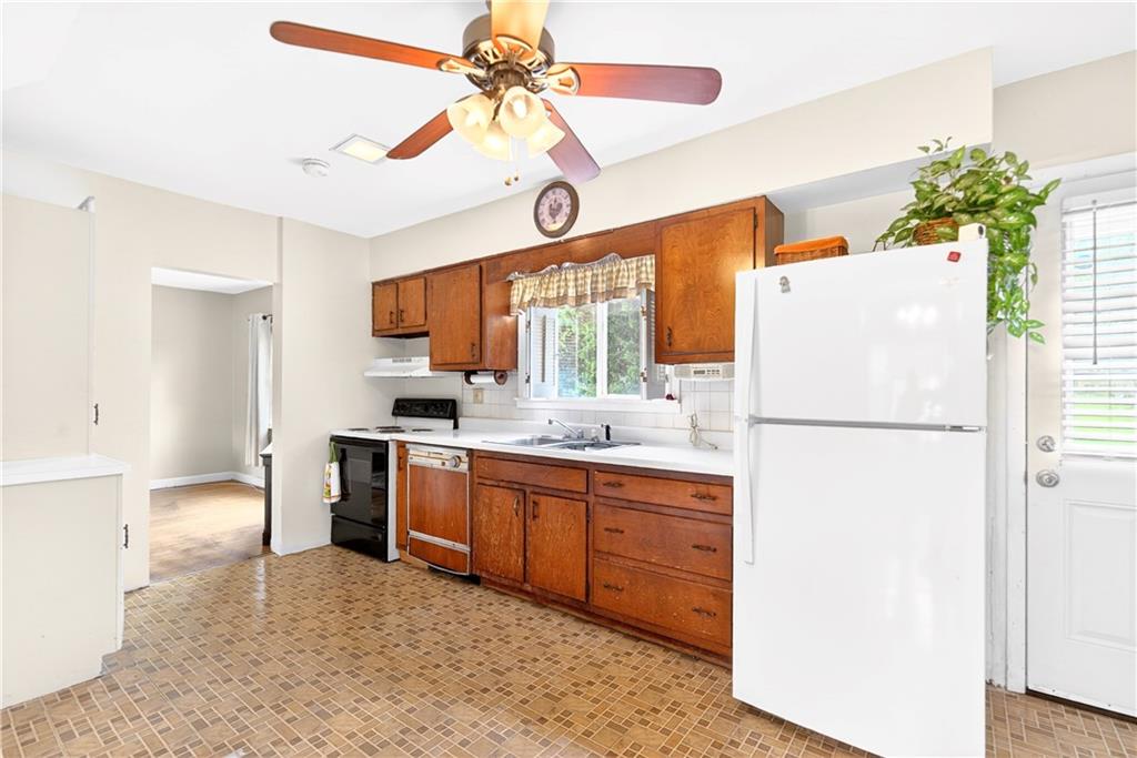 607 Cemetery Road Perryopolis, PA 15473 - Photo 7 of 30 a kitchen with stainless steel appliances chandelier refrigerator and microwave