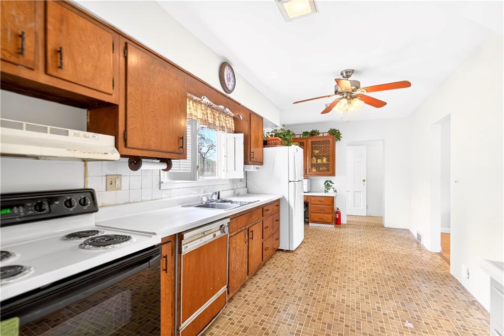 607 Cemetery Road Perryopolis, PA 15473 - Photo 8 of 30 a kitchen with a stove a sink and a refrigerator