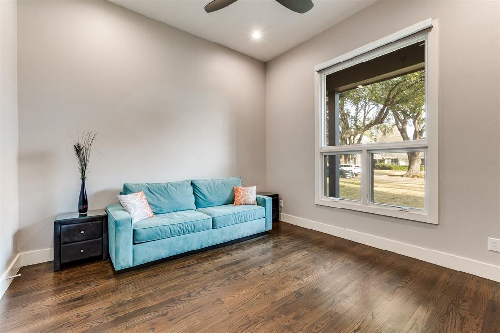 7912 Hanover Street Dallas, TX 75225 - Photo 18 of 29 Hardwood flooring in downstairs bedroom featuring a large window, vaulted ceiling, and recessed lighting