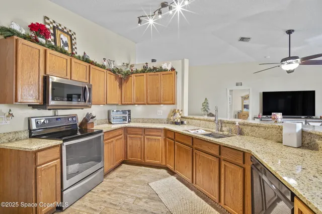 a kitchen with a sink stove and microwave