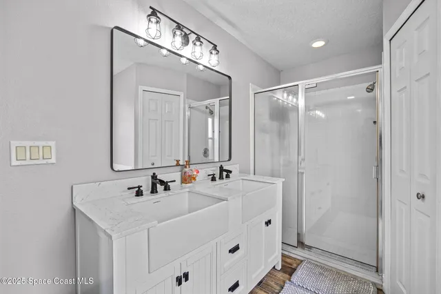 a bathroom with a sink a mirror and a shower