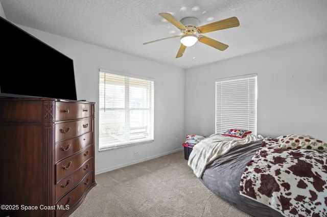 a bedroom with a bed and a tv