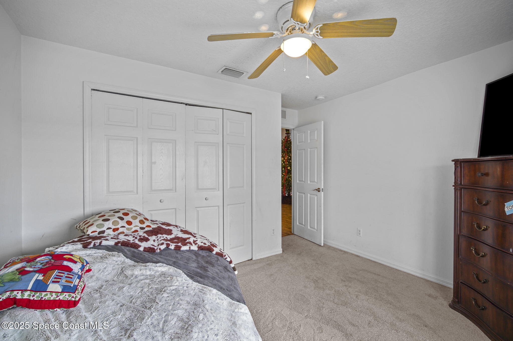 3356 Kilbee Street Mims, FL 32754 - Photo 25 of 28 a bedroom with a bed and a tv in it