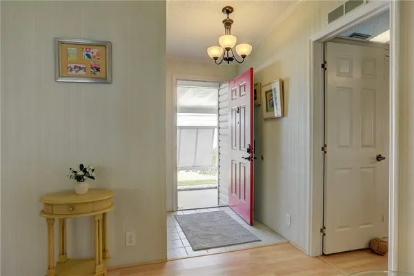 a view of a dining room with furniture and a chandelier