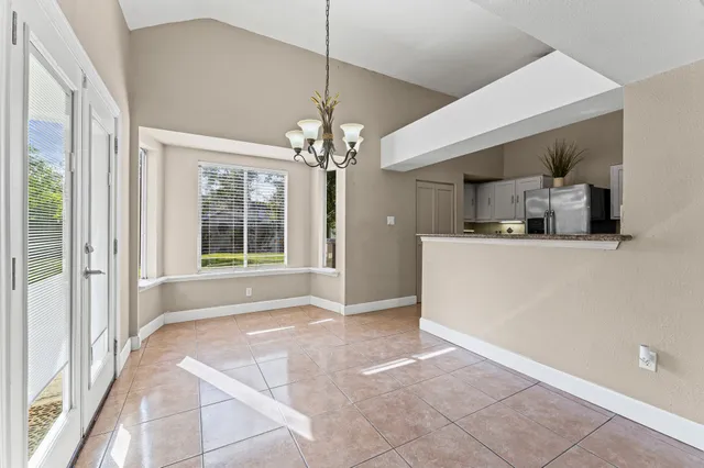 a view of a kitchen with a sink and chandelier